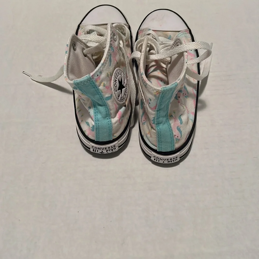 Converse unicorn high top tennis shoe.